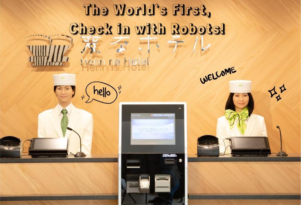 a man and a woman in chefs hats at a cash register at Henn na Hotel Tokyo Akasaka in Tokyo