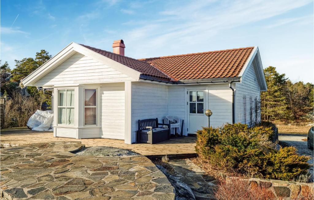 un piccolo cottage bianco con tetto in mattoni di Cozy Home In Sndeled With Kitchen a Søndeled