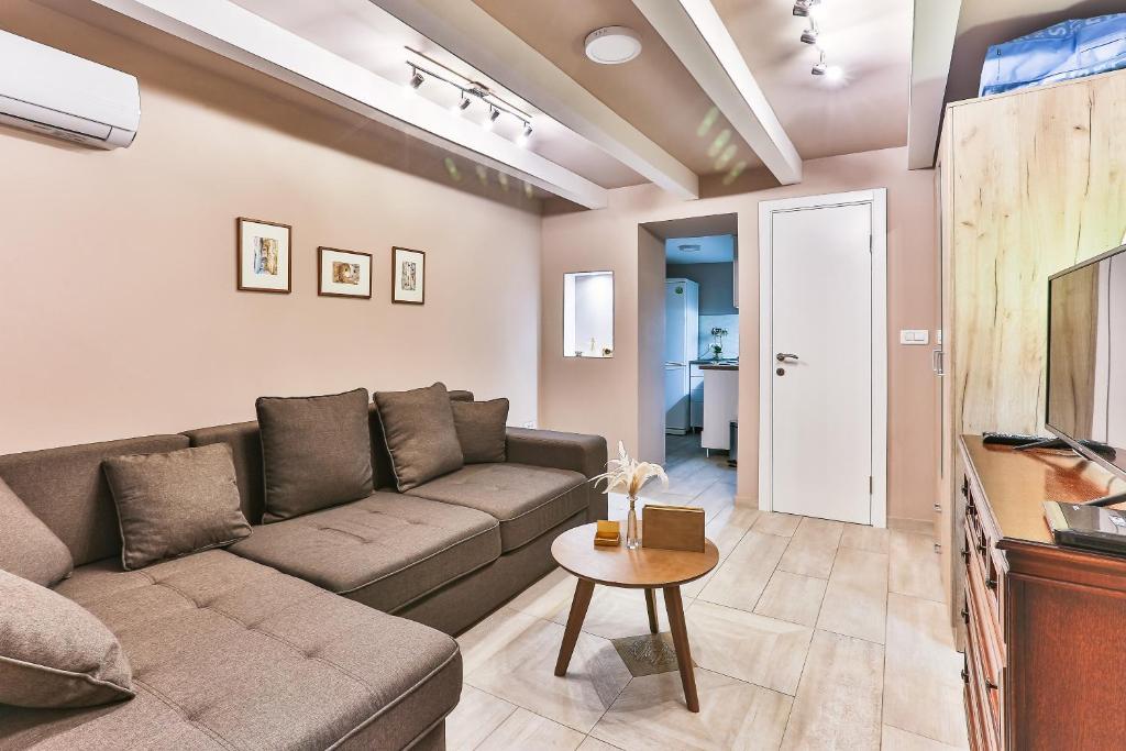 a living room with a couch and a table at Magnolia Lux Apartments in Budva