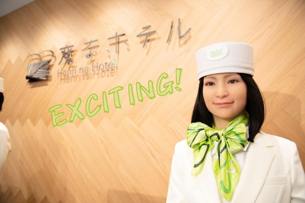 a woman wearing a white hat and a green bow tie at Henn na Hotel Tokyo Akasaka in Tokyo