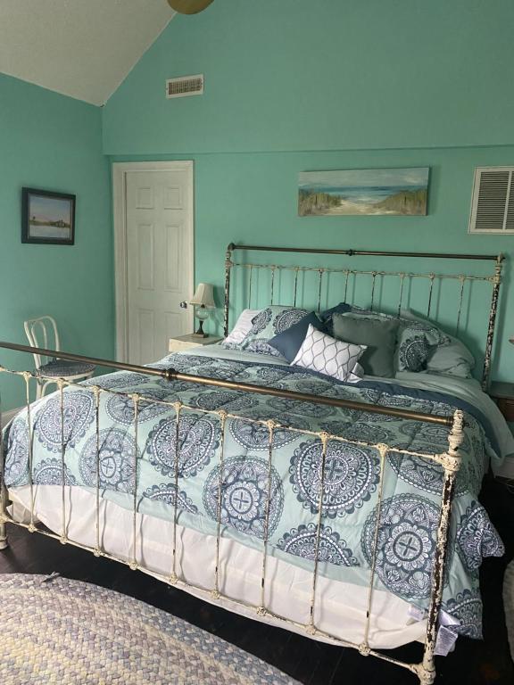 a bedroom with a large bed with blue walls at BEACH HAVEN Dog friendly farmette Great for 2 couples in Berlin