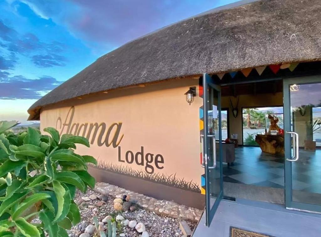 a building with a sign that reads llama lodge at Agama Lodge in Solitaire