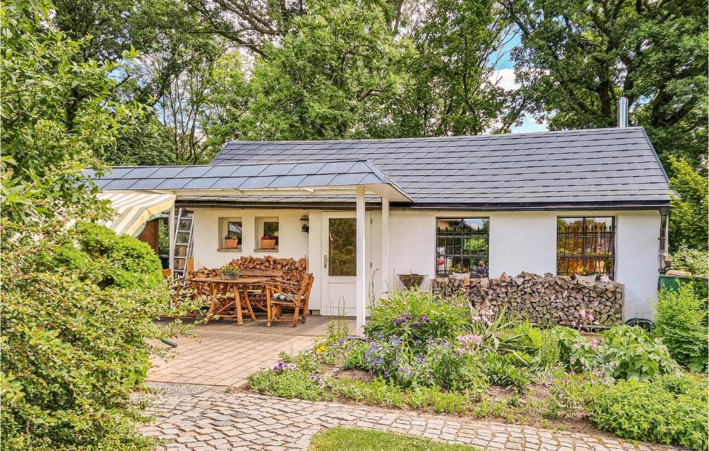 a white house with a patio and a table at Gorgeous Home In Tharandt With Kitchen in Tharandt