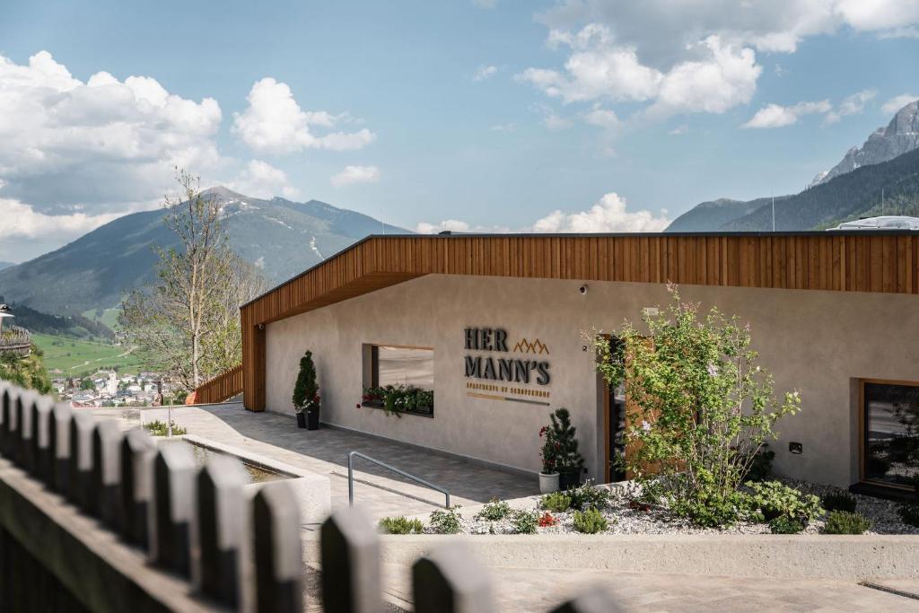 a building with a sign that reads her own maws at Apartments Hermann's in San Candido