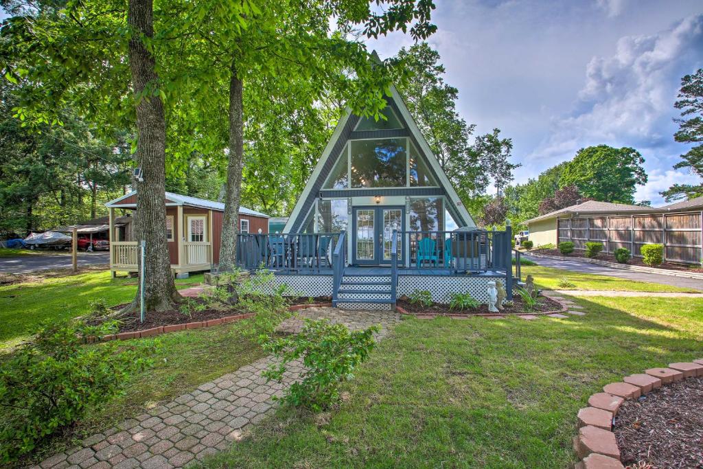 a tiny house with a blue roof at Romantic Pet-Friendly A-Frame on Lake Hamilton! in Hot Springs
