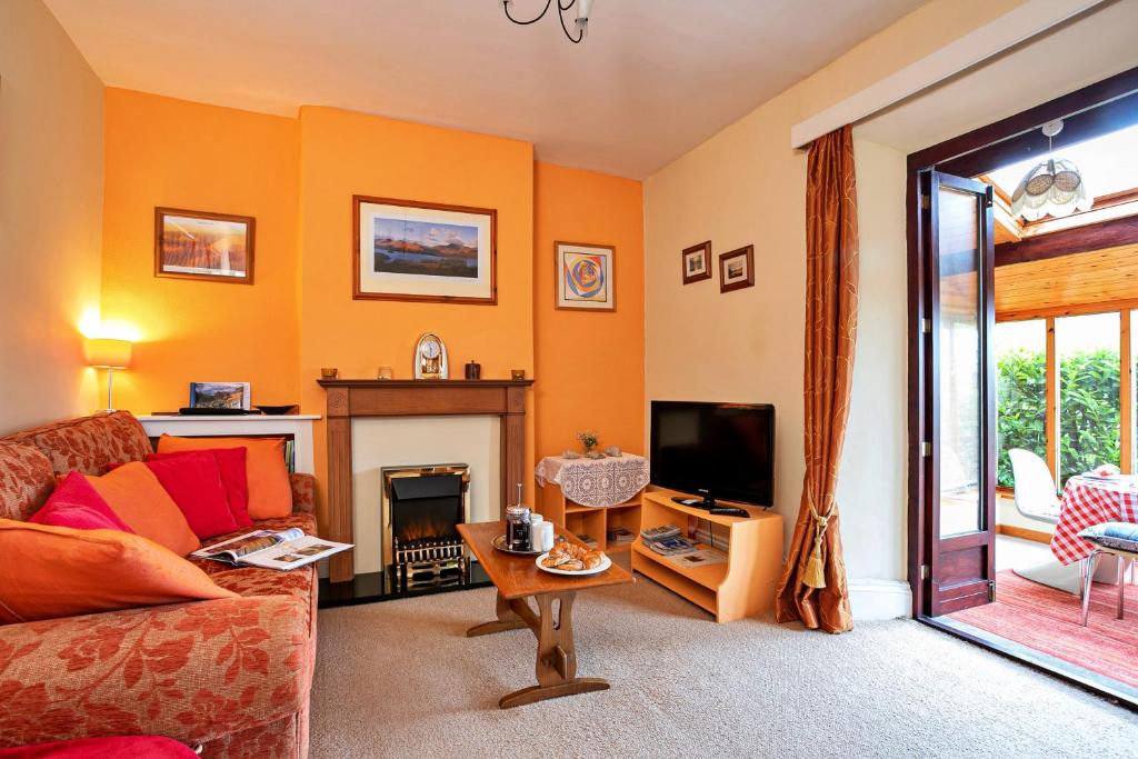 a living room with a couch and a fireplace at Finest Retreats - Sunny Bank in Grange Over Sands