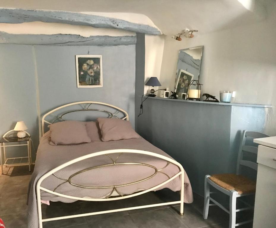 a bedroom with a bed with a metal frame at Apartment Des Romains in Sospel