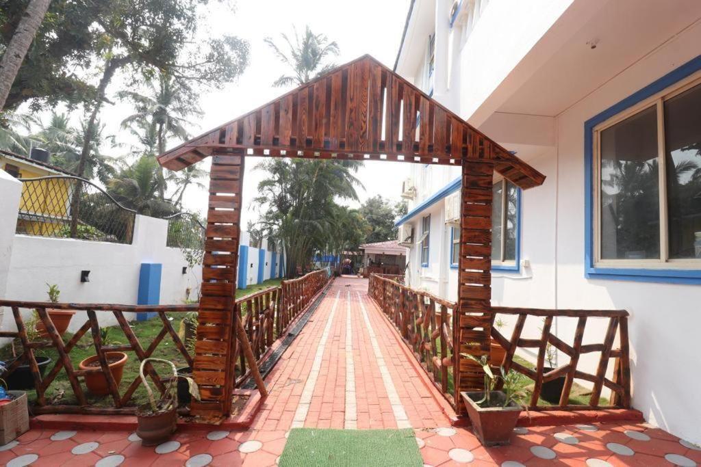 a wooden archway on a walkway in a building at Blue Lagoon Benaulim Goa in Marmagao