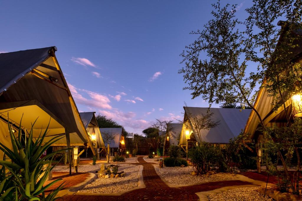 a group of buildings at night with lights at Urban Camp in Windhoek