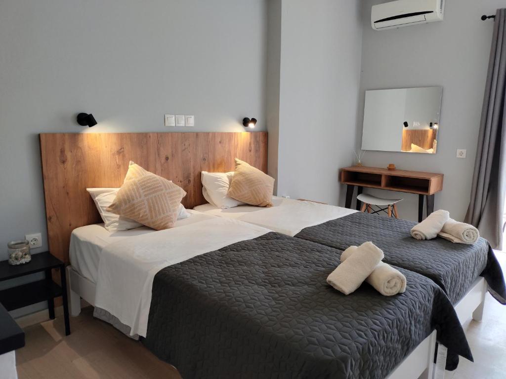 a bedroom with a large bed with two towels on it at Valentinos Apartments in Roda