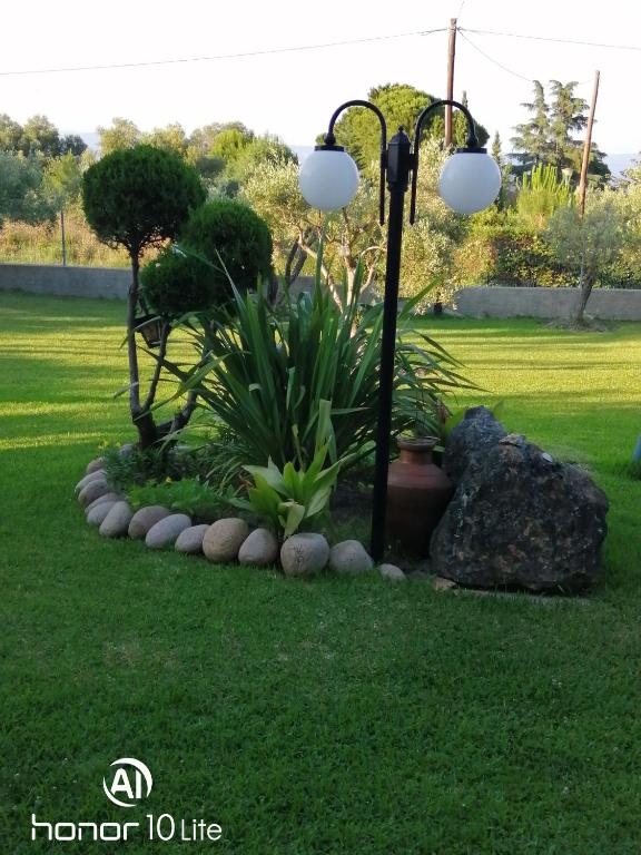 a lamp post in the middle of a lawn at Avra Ηouse in Kriopigi