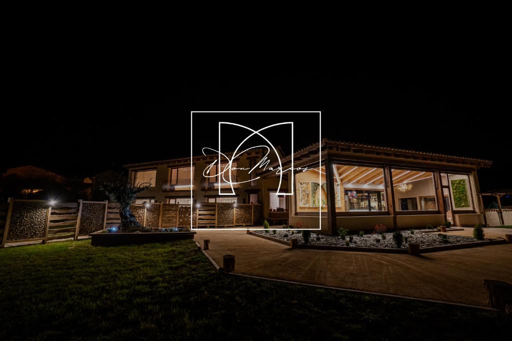 a building with a large sign in front of it at night at Hotel Don Marcos in Osma