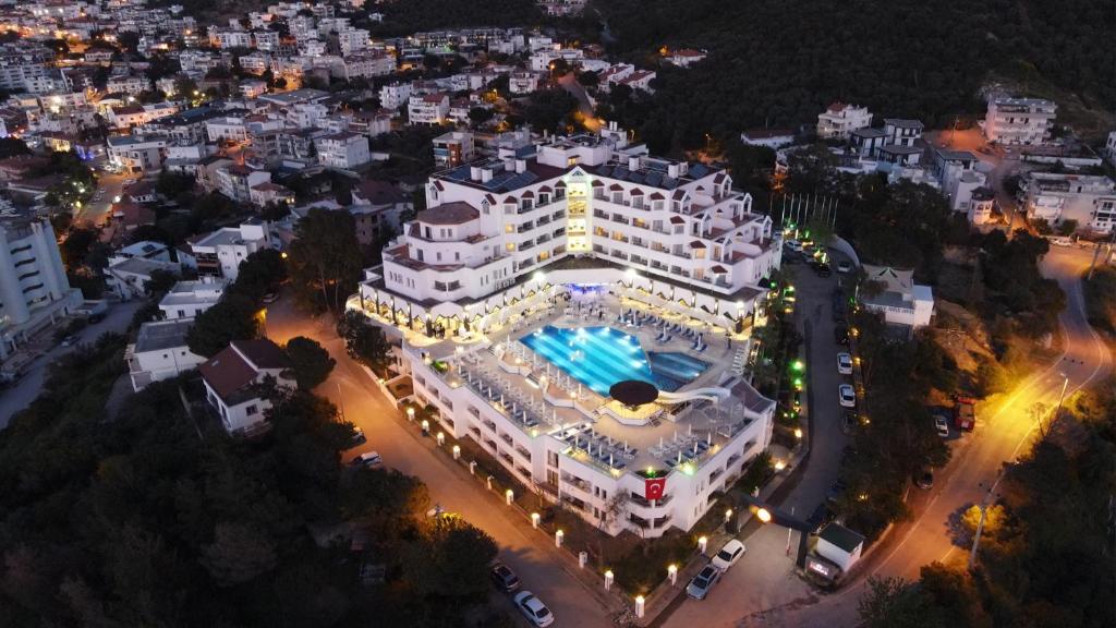 an overhead view of a large white building with a pool at Roseira Beach Resort in Gulluk