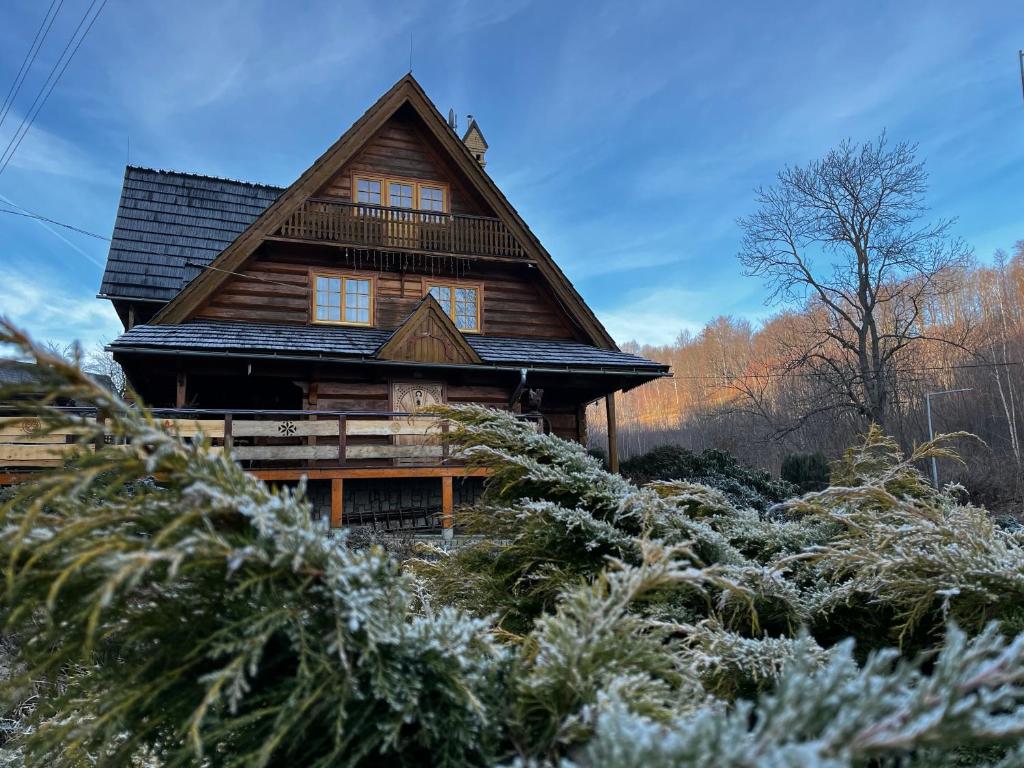 a log cabin with snow on the ground at Chata Sosnówka Residence in Sosnówka