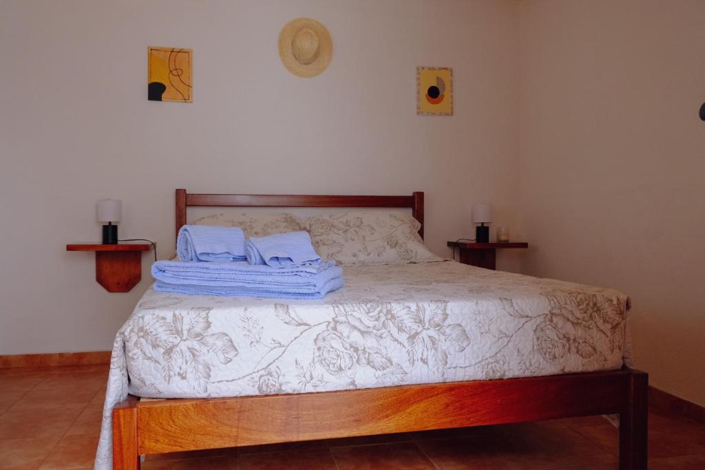 a bedroom with a bed with towels on it at Casinha da Eira in Góis