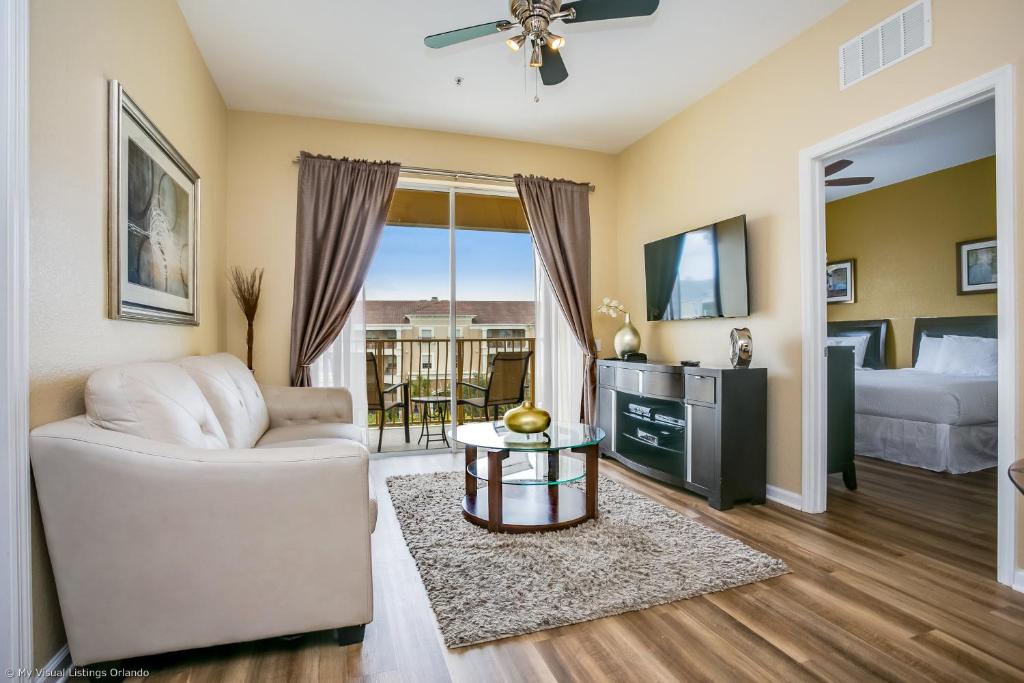 een woonkamer met een witte bank en een tv bij 4814 Cayview Avenue #401 in Orlando