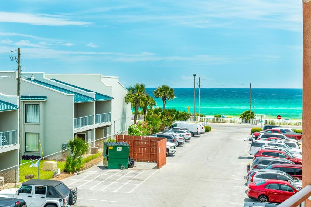 a row of cars parked in a parking lot next to the beach at Gulfview II 301 in Destin