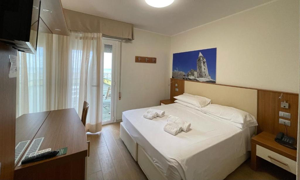 Postel nebo postele na pokoji v ubytování Hotel Verona