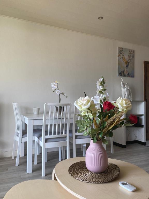 a vase with flowers on a table in a room at Magic&#39; Chambord in Albertville