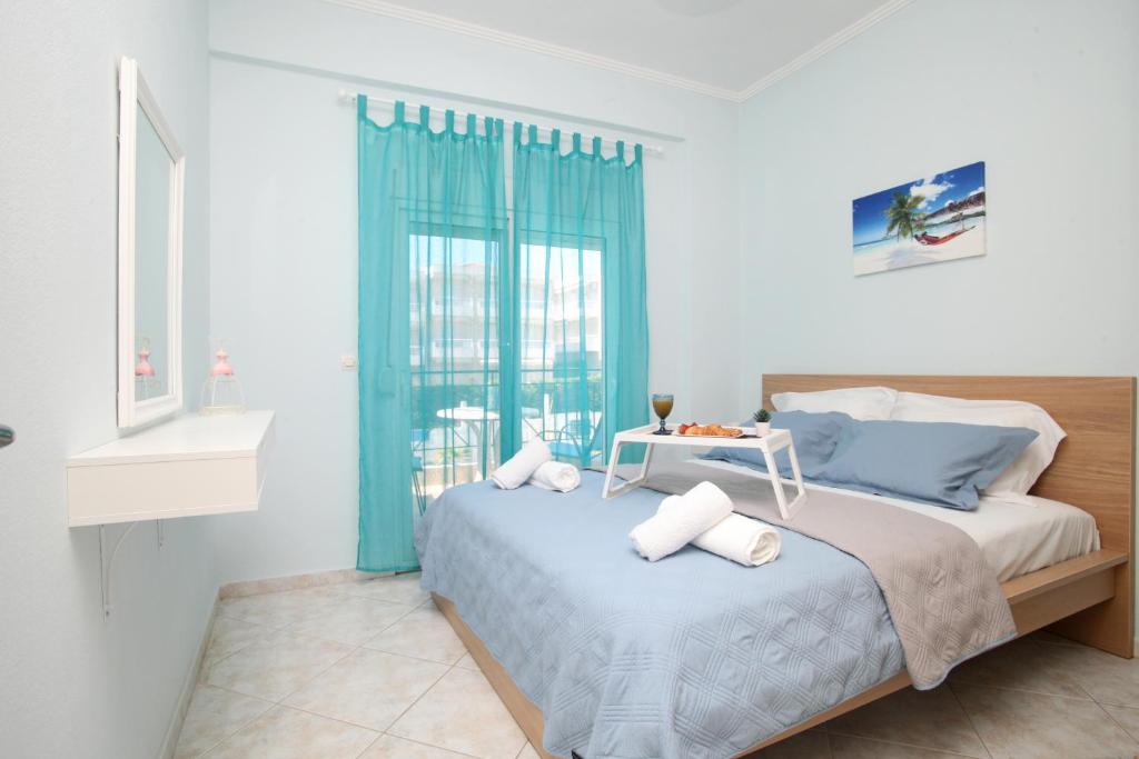 a bedroom with a bed with a table on it at Blue Deluxe Apartment in Kallithea Halkidikis