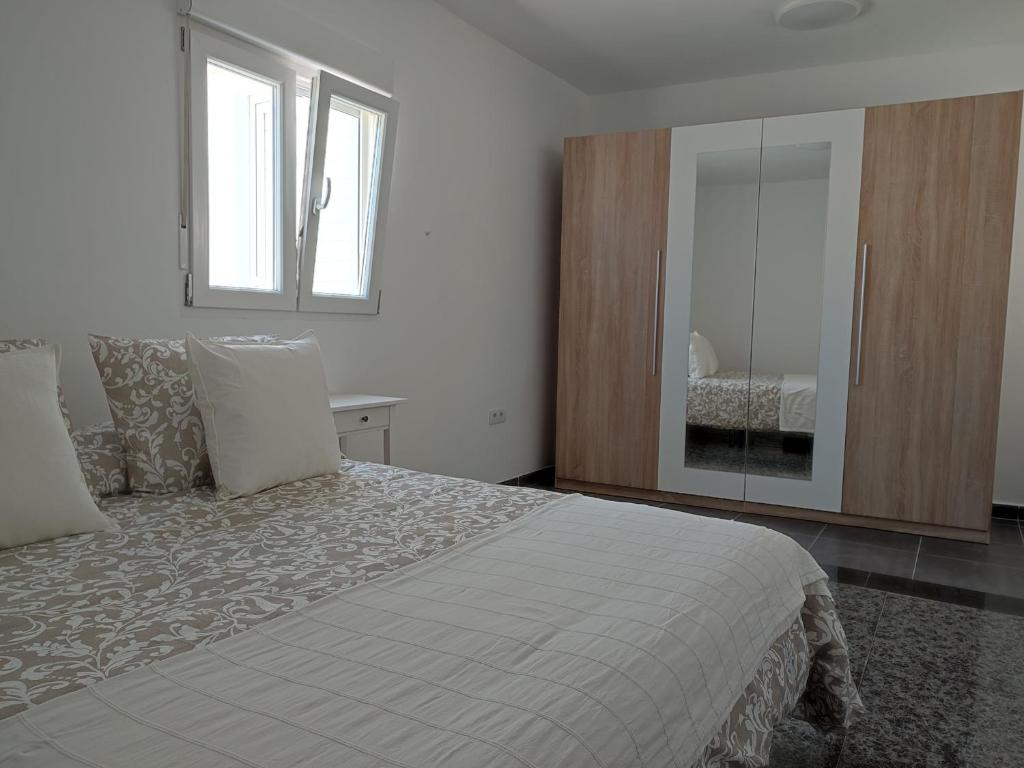 a bedroom with a white bed and a window at Casa Luisi in Playa Honda