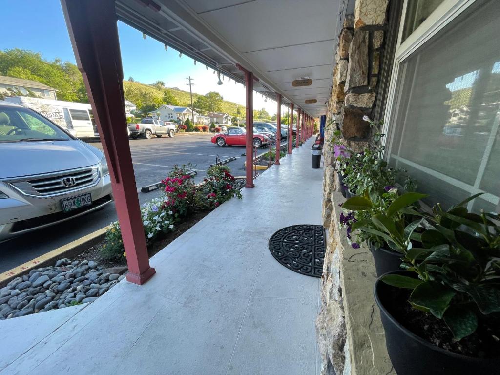 a porch with plants on the side of a building at Rugged Country Lodge in Pendleton