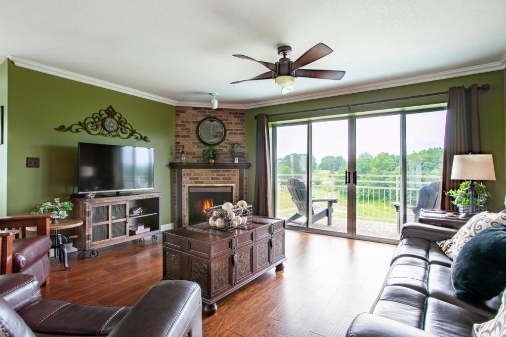a living room with a couch and a fireplace at Penthouse Paradise - Fireplace and Mountain View in Pigeon Forge