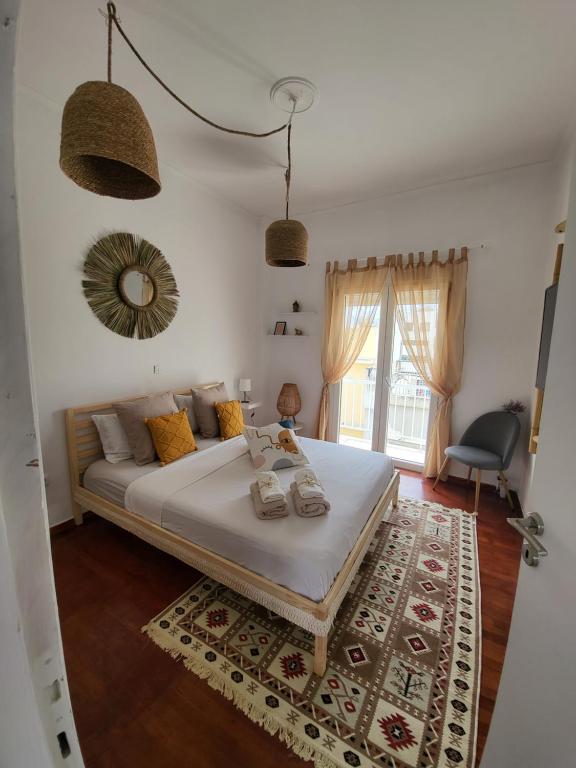 a bedroom with a large bed and a window at Viva La Veranda Apartment in Central Athens in Athens