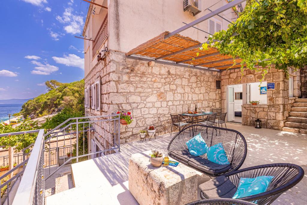 a patio with two chairs and a table on a building at Apartman Daniela in Sobra