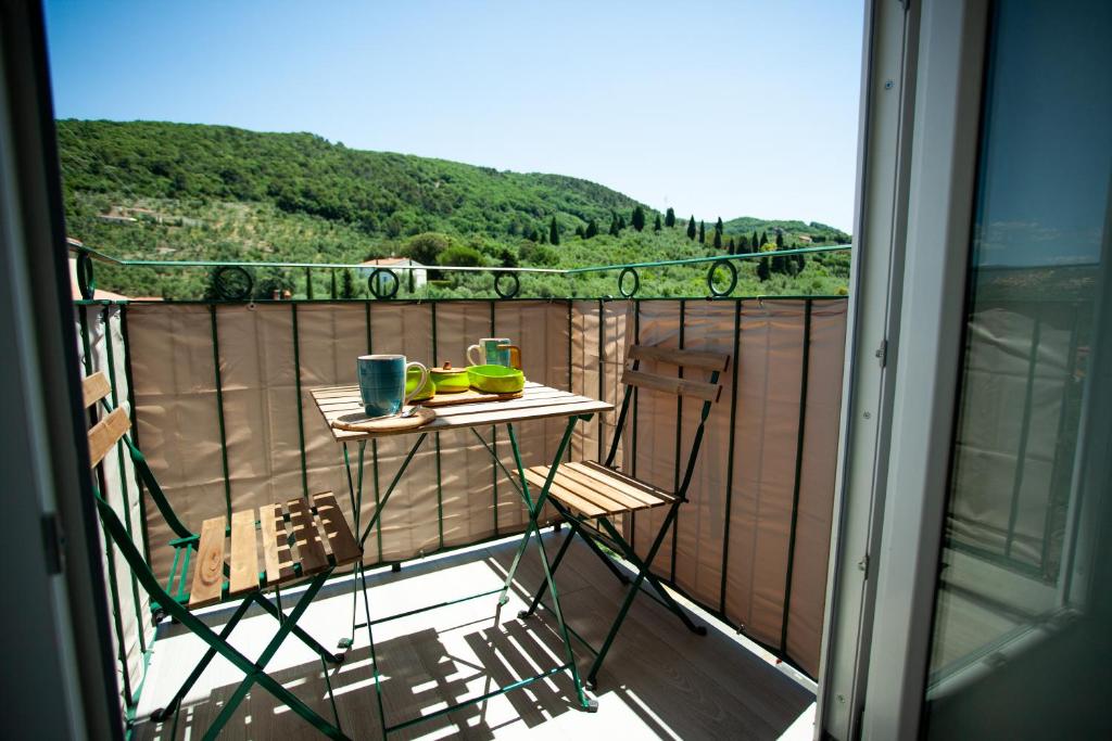 a balcony with a table with two mugs on it at Openspace a pochi passi dal mare in Lerici
