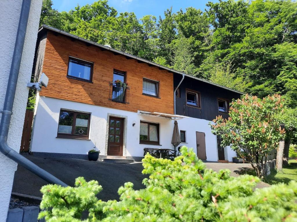 a house with a lot of windows and trees at Ferienwohnung Oberschledorner Wald in Medebach
