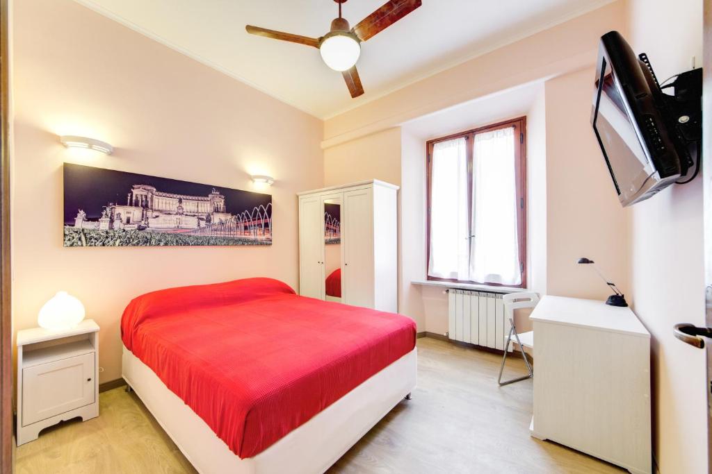 a bedroom with a bed and a flat screen tv at Apartment Colosseo in Rome