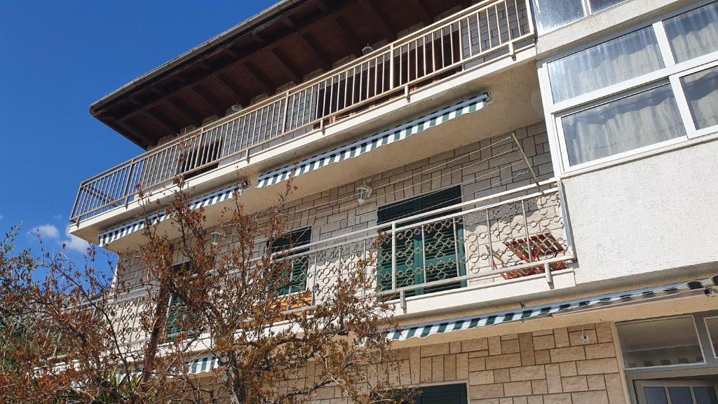 a building with a balcony on the side of it at Toni&Megi Apartment in Jesenice