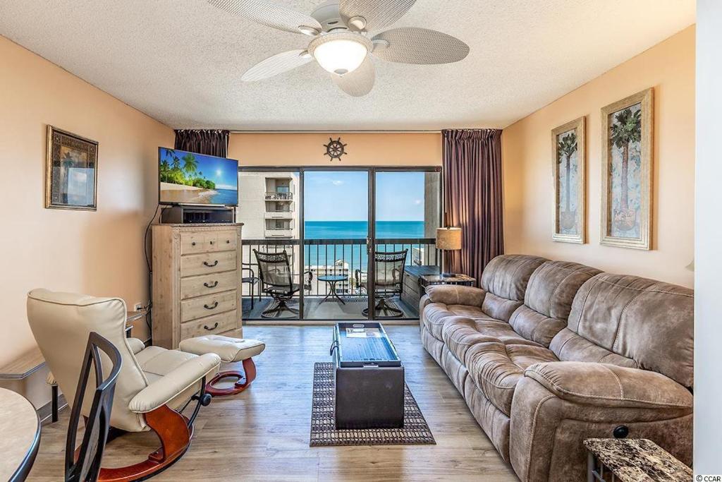 a living room with a couch and a view of the ocean at Spacious Ocean View Suite With Beautiful Updates! - Ocean Dunes Tower 2 Unit 6121 - Sleeps 6 Guests! in Myrtle Beach