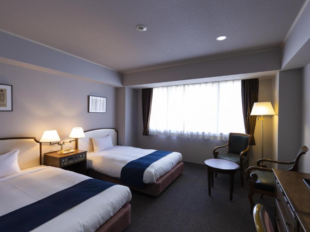 Postel nebo postele na pokoji v ubytování Ariston Hotel Kobe