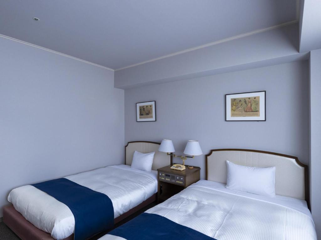 Postel nebo postele na pokoji v ubytování Ariston Hotel Kobe