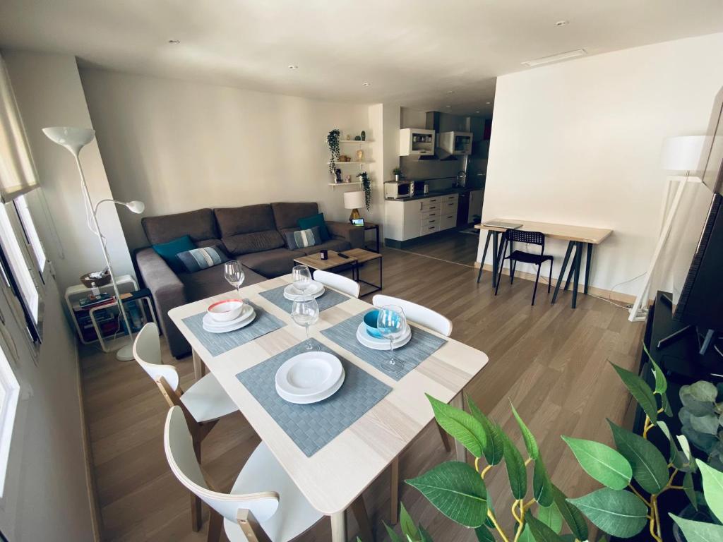 a dining table and chairs in a living room at Fantastic Apartment City Center - Optional Parking in Málaga