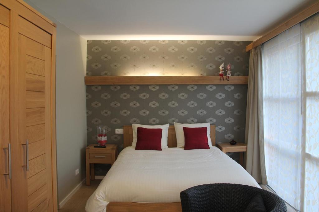 Postel nebo postele na pokoji v ubytování B&B Het KoeKoeKsnest Schelle