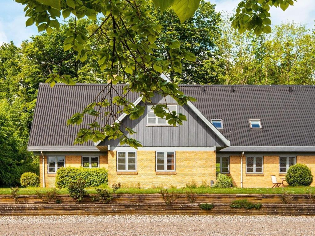 a brick house with a black roof at Holiday home Silkeborg XVII in Silkeborg