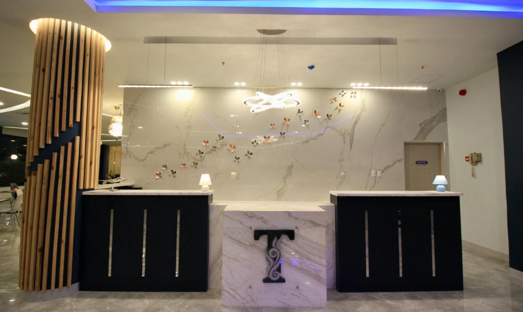 a counter in a room with a marble wall at T Shine Resort and Spa in Mactan