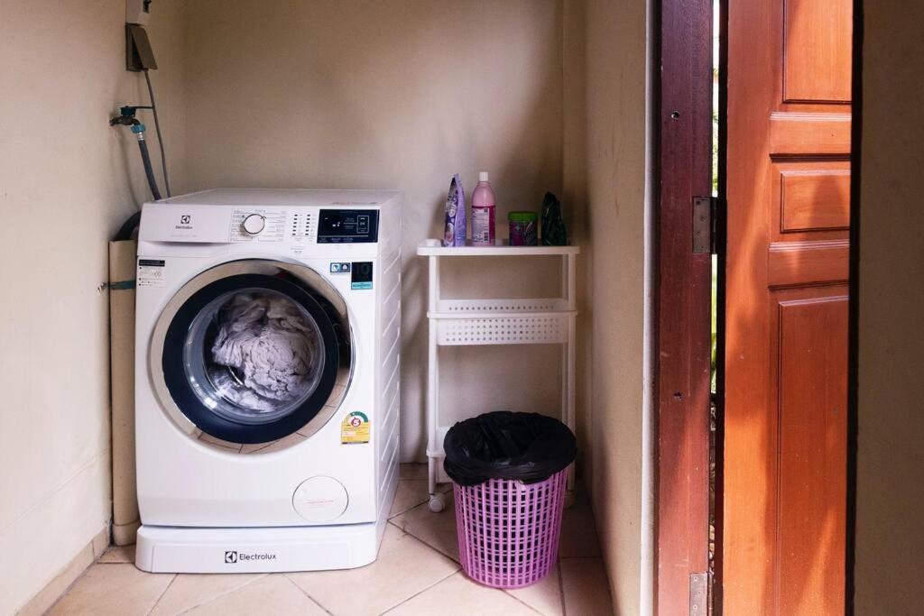 a washing machine in a laundry room with a basket at Family-friendly house, a few steps from the pool and close to the ocean. in Mae Pim