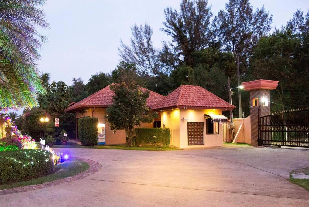 a house with a driveway in front of it at Family-friendly house, a few steps from the pool and close to the ocean. in Mae Pim