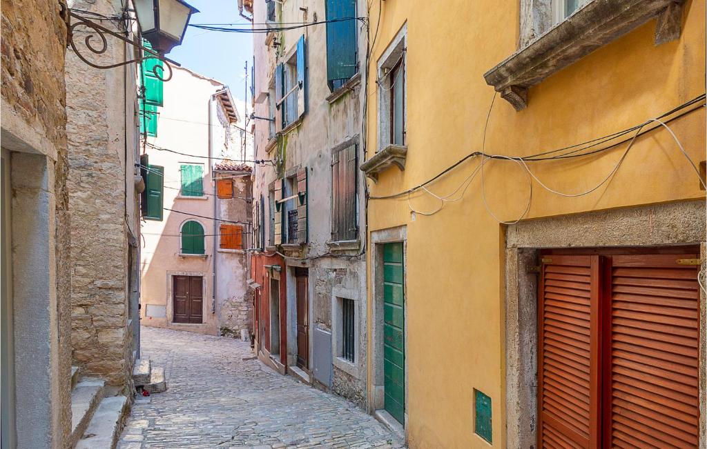 an alley in an old town with buildings at Beautiful Apartment In Rovinj With Kitchen in Rovinj