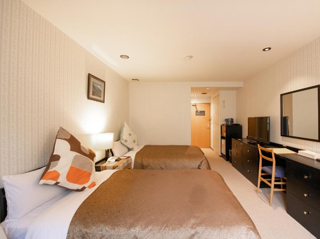 Postel nebo postele na pokoji v ubytování Tabist Hotel Colosseum Inn Tateshina