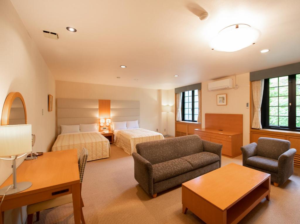 Postel nebo postele na pokoji v ubytování Tabist Hotel Colosseum Inn Tateshina