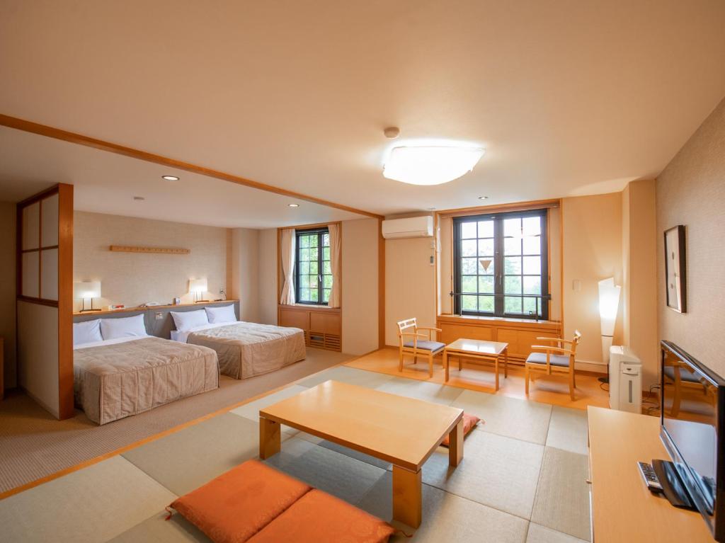 Postel nebo postele na pokoji v ubytování Tabist Hotel Colosseum Inn Tateshina