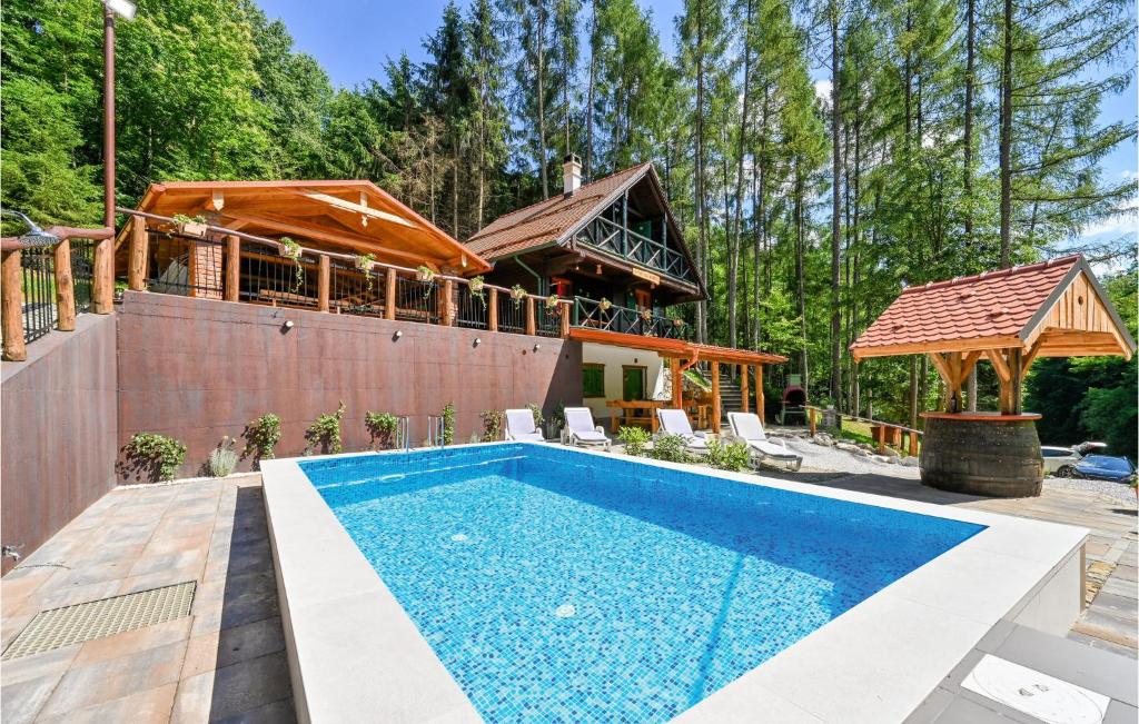 a house with a swimming pool and a building at Beautiful Home In Klenovnik With Sauna in Klenovnik