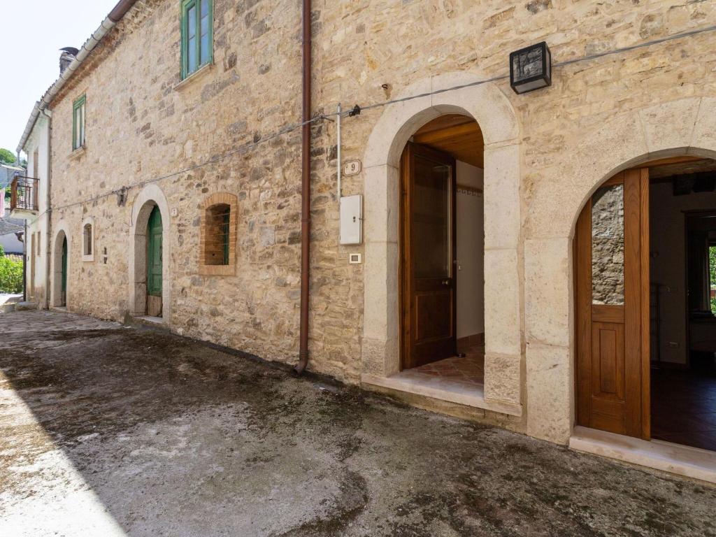 a stone building with two arched doors on it at Stunning Apartment in Ripabottoni with Swimming Pool in Ripabottoni
