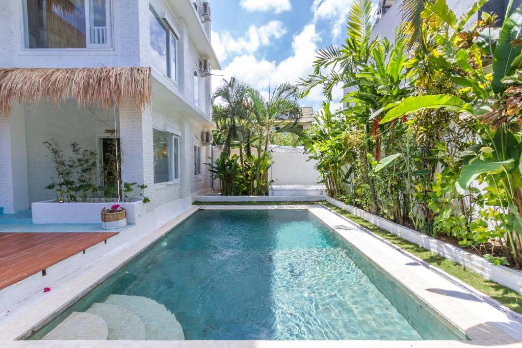 a swimming pool in the backyard of a house at Guru Canggu in Canggu