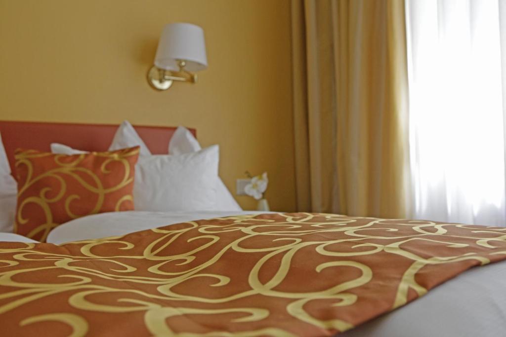 Uma cama ou camas num quarto em Hotel Domizil